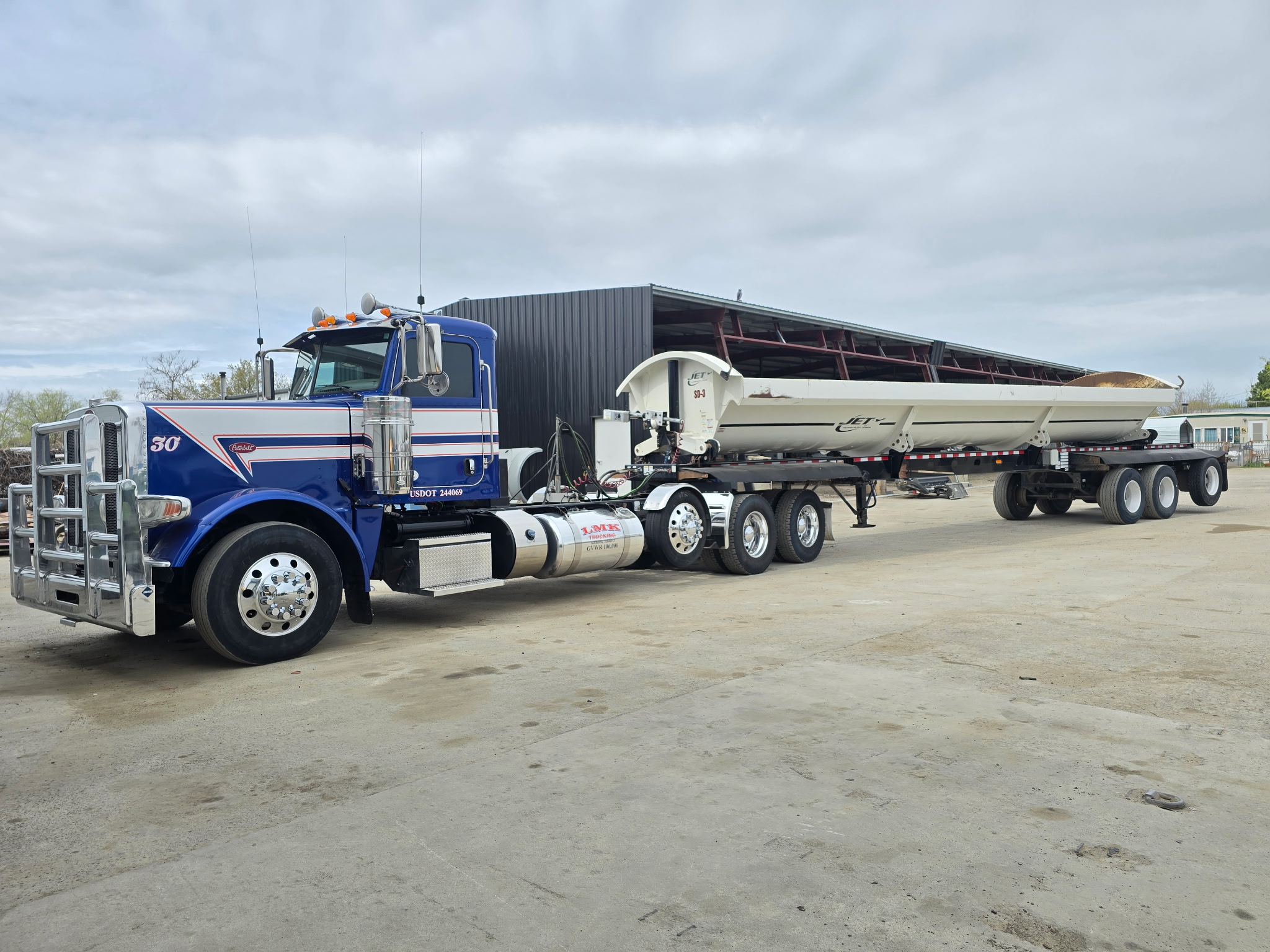 Blue LMK Peterbilt side dump truck